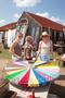 Photograph: [Colorful Roulette Fun: Three Women Enjoying Market Games]