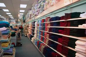 Primary view of object titled '[Shelves of colorful fabric products at Evers Hardware]'.