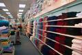 Thumbnail image of item number 1 in: '[Shelves of colorful fabric products at Evers Hardware]'.