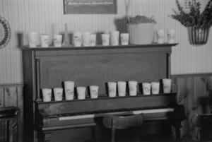 [Cups on a piano at the home of Willard Watson, "The Texas Kid", 2]