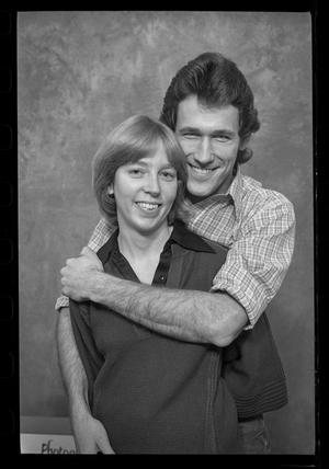 [Man Hugging a Woman from Behind in a Studio]