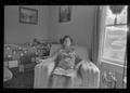 Thumbnail image of item number 1 in: '[Elderly woman frowning and sitting in an armchair]'.
