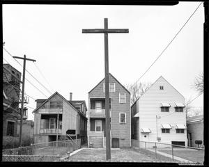 [Large wooden cross in the backyard of a home]