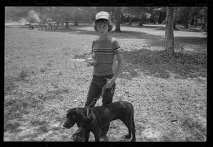 [Young boy with a dog and a trophy]
