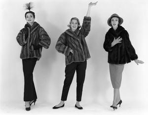 [Three women posing in fur coats]