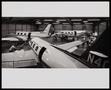 Photograph: [Men working on airplanes in a hangar]