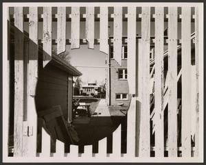 Primary view of object titled '[A wooden fence with a circular cutout]'.