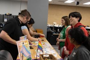 [Spark employees helping students craft buttons, 2]