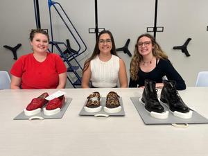 [Three Texas Fashion Collection staff sitting next to artifacts]