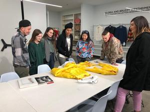 [Students examine a suit designed by Michael Faircloth]