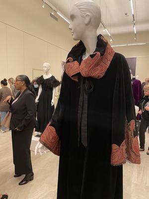 [A mannequin supporting a 1920s paisley and velvet coat]
