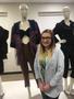 Photograph: [Courtlyn Liska standing in front of her designs]