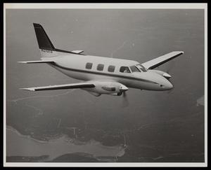 [An airplane labeled "N2101S" flying over land, 2]