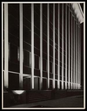 [Exterior of an office building at night]