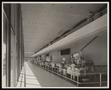Photograph: [A line of machinery inside a Coca-Cola bottling plant]