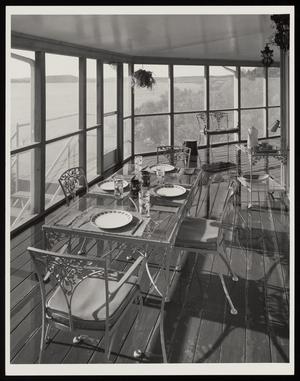[A glass dining table in an enclosed, windowed walkway, 1]