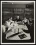 Photograph: [Executives at a conference table regarding Stratoflex, 1]
