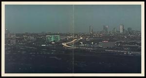 [Aerial view of the illuminated Dallas skyline]