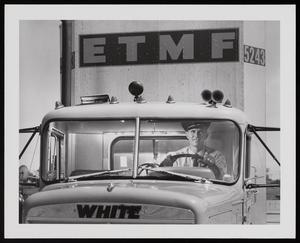 [A man driving an East Texas Motor Freight vehicle]