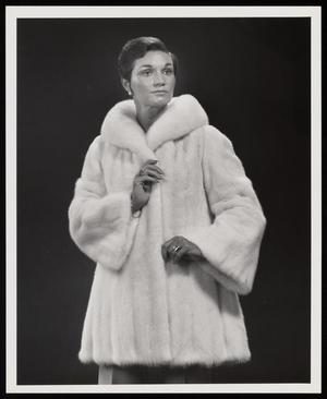 [A woman in a pale fur coat posing, 1]