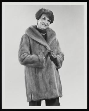 [A woman in a fur coat and gloves]