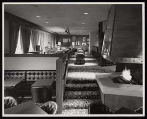[Interior of a restaurant with a fireplace and carpeting]