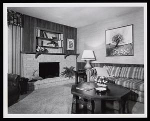 [A living room interior with a fireplace and striped couch]