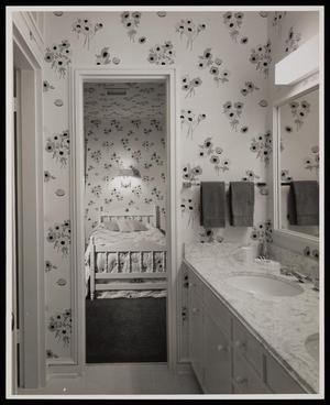 [A bathroom and bedroom with floral wallpaper]