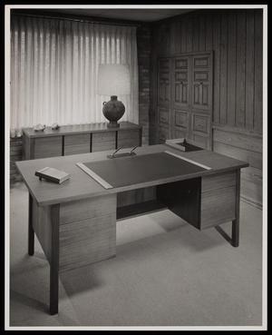 [A desk in front of a table with turtle sculptures]