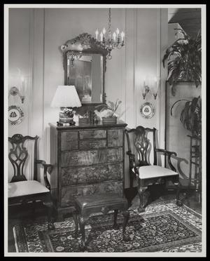 [A mirror and a chandelier above a cabinet]