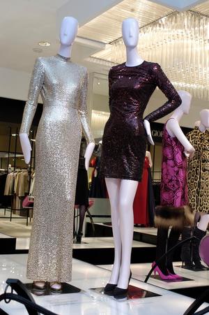 [Two sequin evening dresses on display]