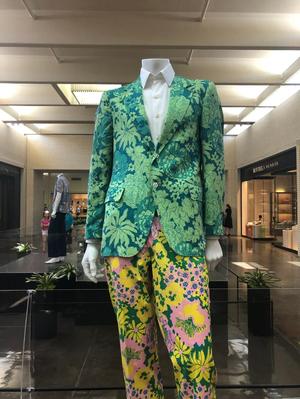 [A green floral jacket and multicolored pants]