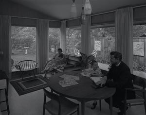 [A family and clergyman sitting in a home, 1]
