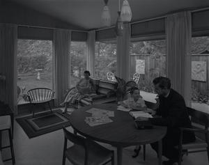[A family and clergyman sitting in a home, 2]