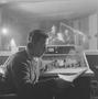 Photograph: [A man smoking in a recording room, 4]