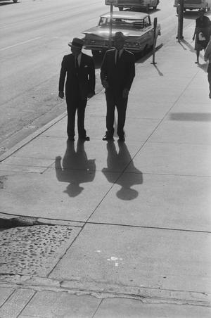 [Two men standing near a parked car, 2]