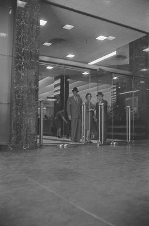 [A woman and two men at Tracy-Locke in Dallas]