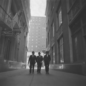 [Three suited men on a dark street, 6]