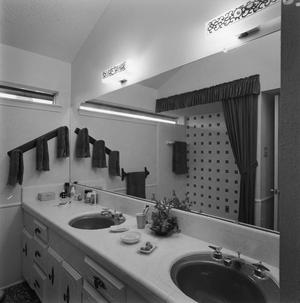 [A bathroom with dark sinks, 1]