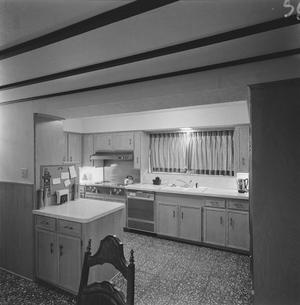 [A kitchen with wooden cabinets, 1]