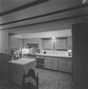 [A kitchen with wooden cabinets, 2]