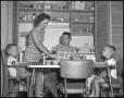 Photograph: [Graduate Family at Kitchen Table]
