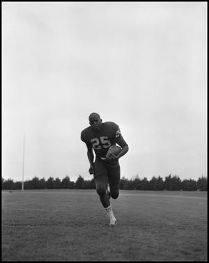 Primary view of object titled '[Football Player No. 25 Running with a Football, September 1962]'.