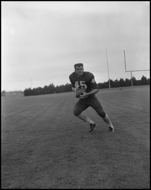 [Football Player No. 45 Running with a Football, September 1962]