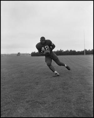Football Player No. 42 Running with a Football, September 1962]