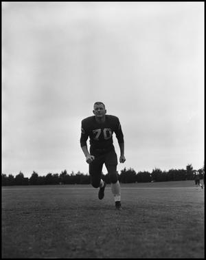 [Football Player No. 70 Running on the Field, September 1962]