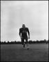 Photograph: [Football Player No. 70 Running on the Field, September 1962]