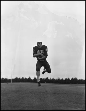 [Football Player No. 45 In midair with a Football, September 1962]