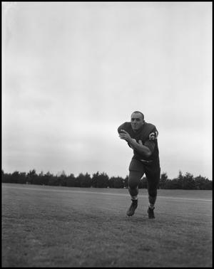 [Football Player No. 61 Running on the Field, September 1962]