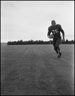 [Football Player No. 36 Running with a Football, September, 1962]